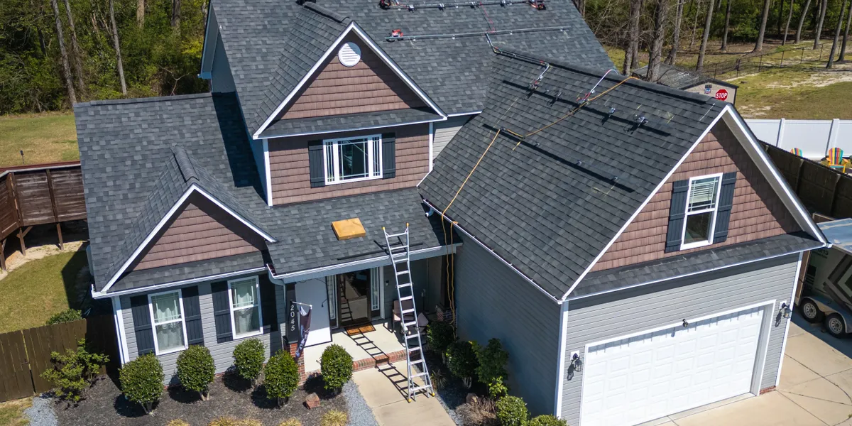 Completed roof replacement project — modern home with new architectural shingles